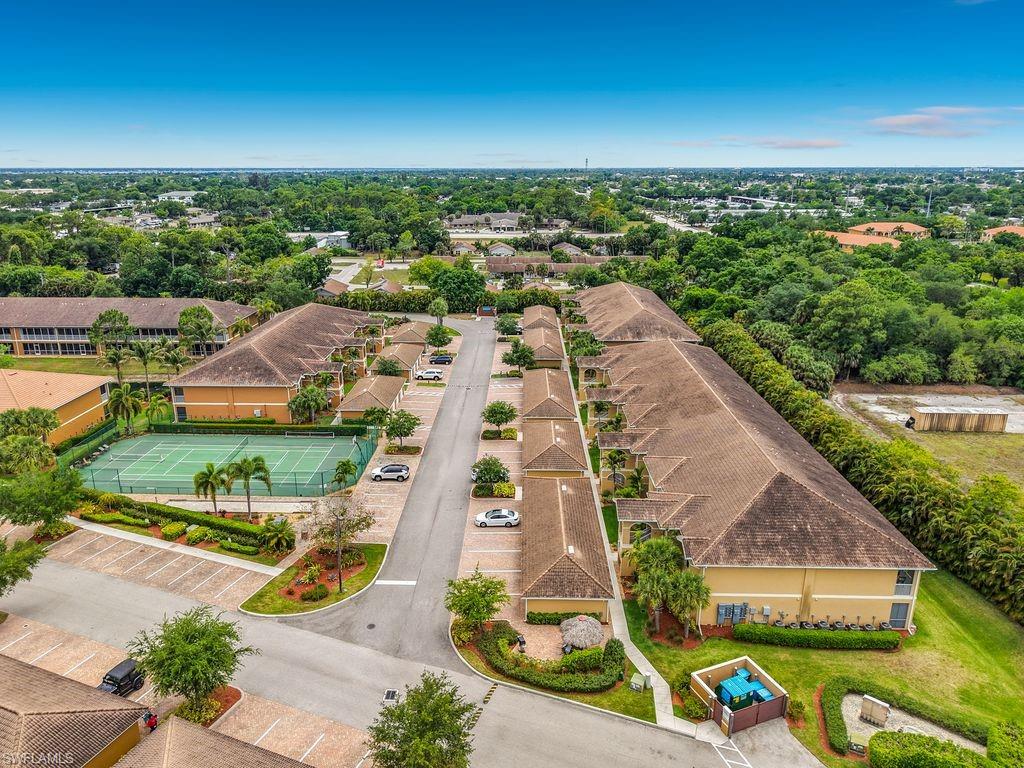 Community property featuring multiple buildings with terracotta-style tile roofs