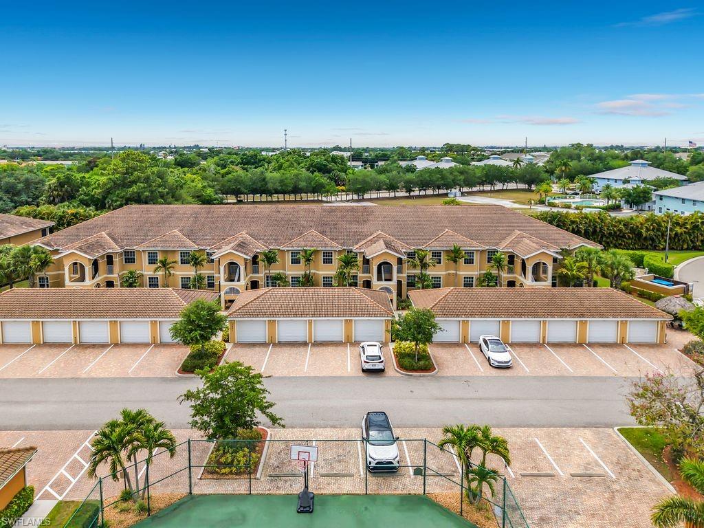 Multi-unit complex featuring tan stucco exteriors and tile roofs