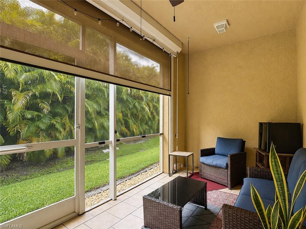 Screened lanai featuring privacy shades and string lighting