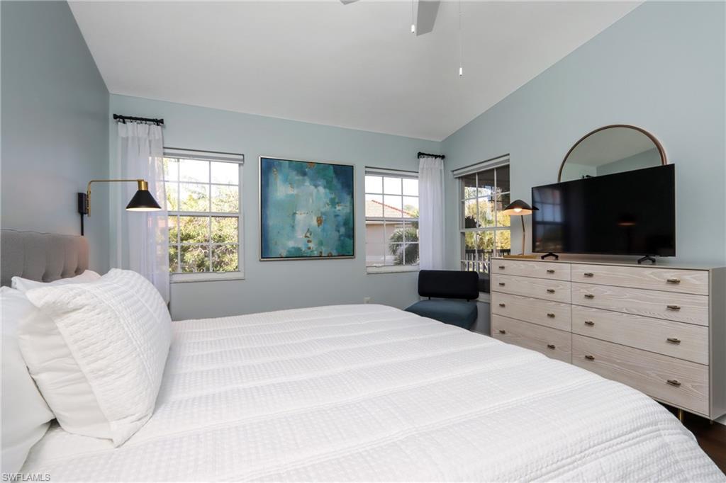 Bedroom featuring lofted ceiling, ceiling fan, and wood finished floors
