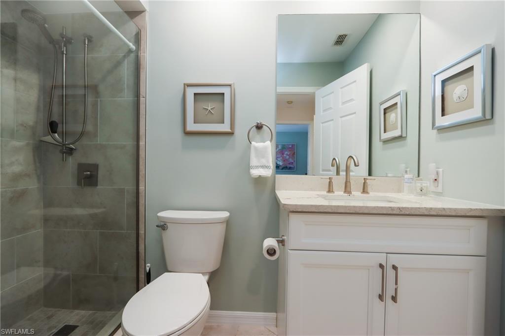 Bathroom featuring vanity and a stall shower