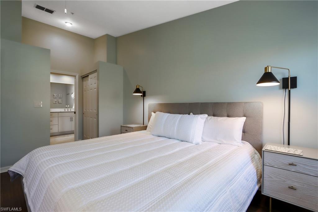 Bedroom featuring ensuite bath and wood finished floors