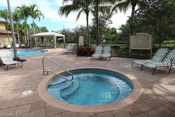 View of swimming pool featuring a gazebo and a hot tub