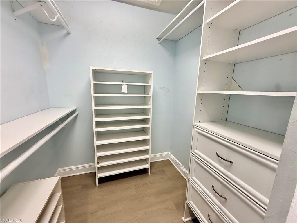 Dual walk in closets with built in shelving.