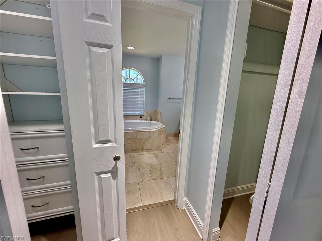 Dual walk in closets with built in shelving.