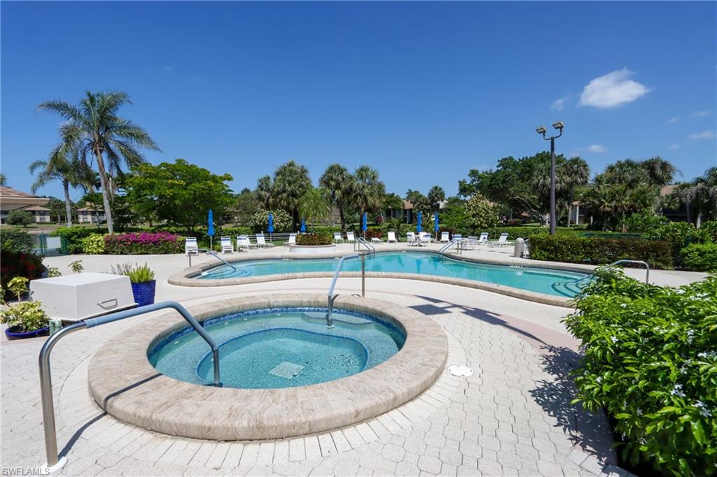 Community pool featuring a hot tub and a patio area