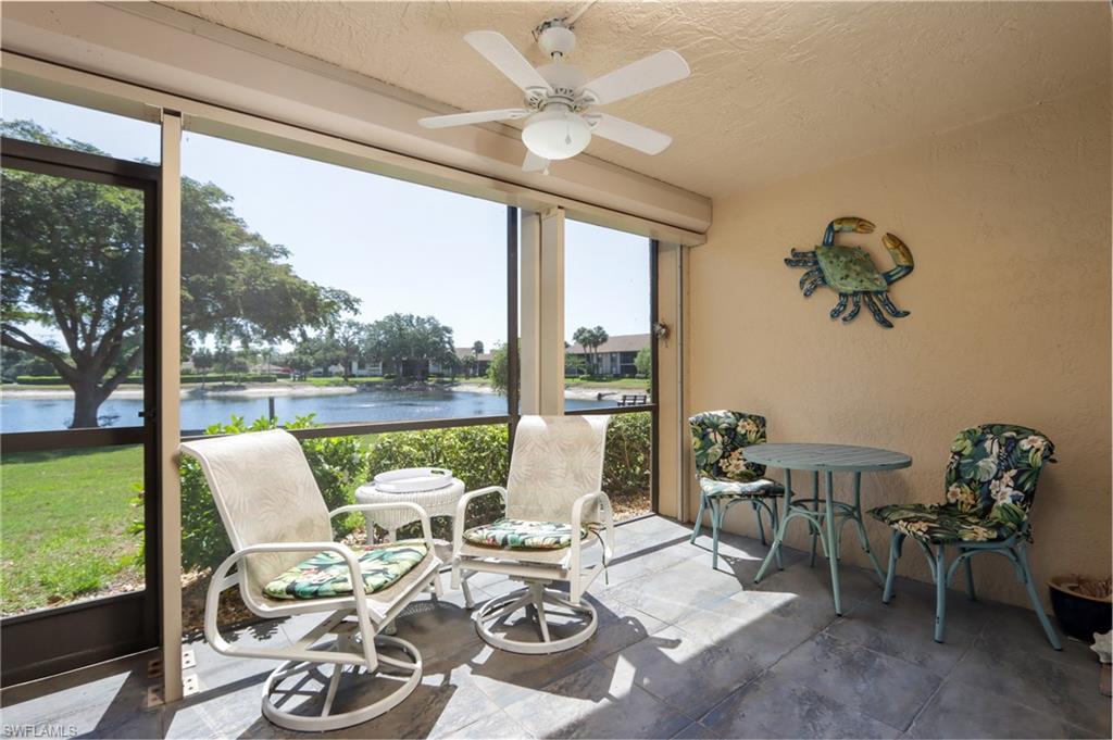 Sunroom with a water view, healthy amount of natural light, and a ceiling fan