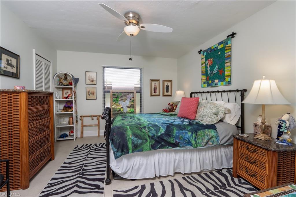 Bedroom with light colored carpet and ceiling fan
