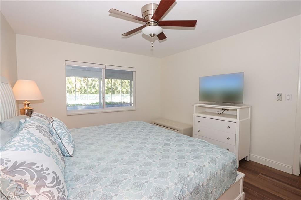Bedroom with dark wood-type flooring and ceiling fan