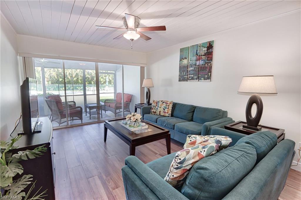 Living room with wooden ceiling, ceiling fan, and wood-type flooring
