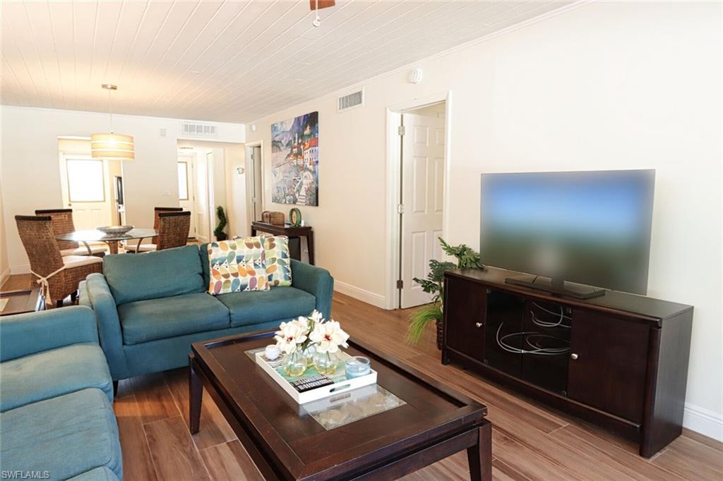 Living room with hardwood / wood-style flooring and wooden ceiling