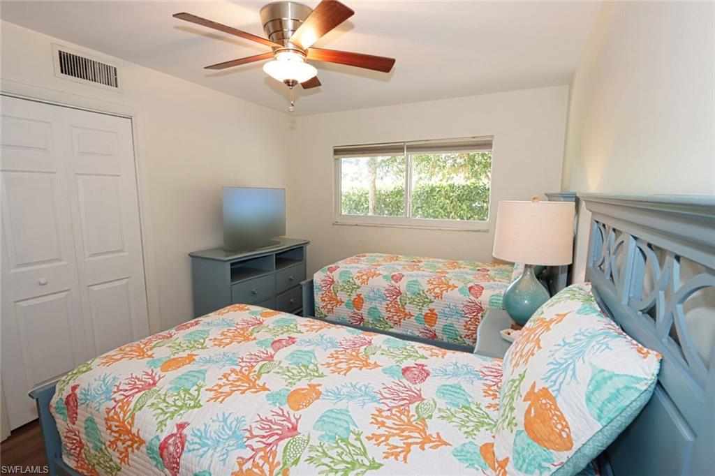 Bedroom featuring hardwood / wood-style flooring, ceiling fan, and a closet