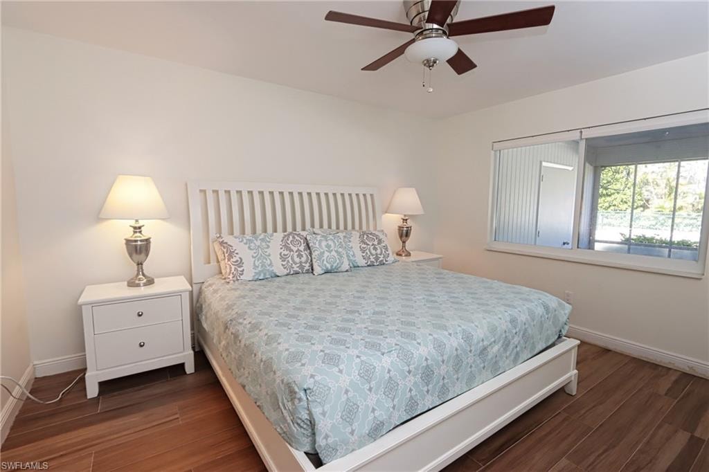 Bedroom featuring dark wood-type flooring and ceiling fan
