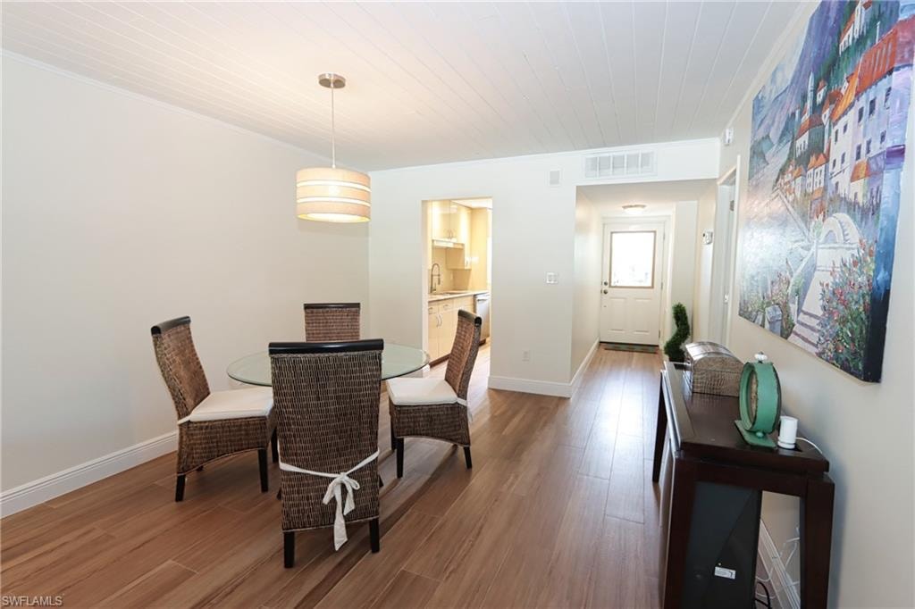 Dining room with sink and hardwood / wood-style flooring