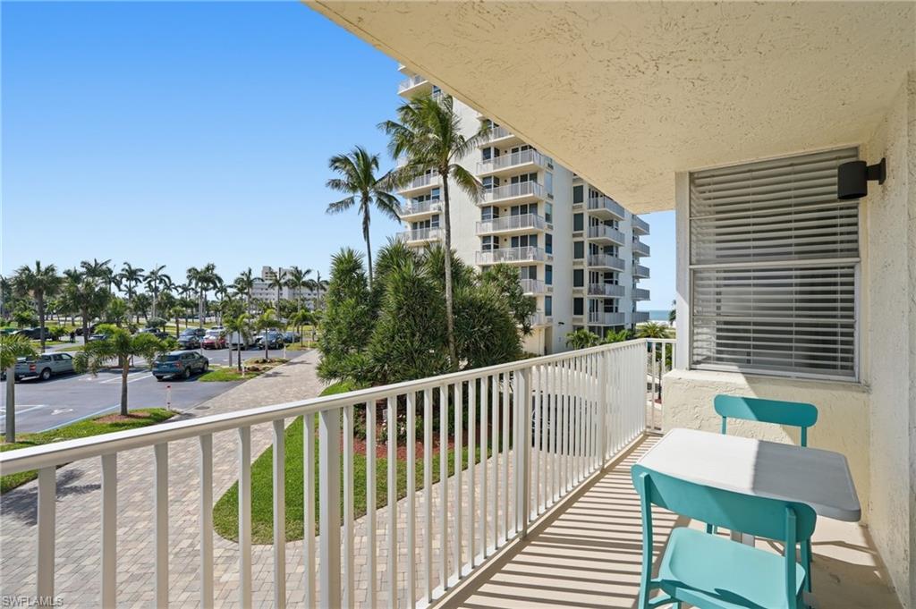 Balcony with white railing and textured exterior wall - Virtually Edited Image