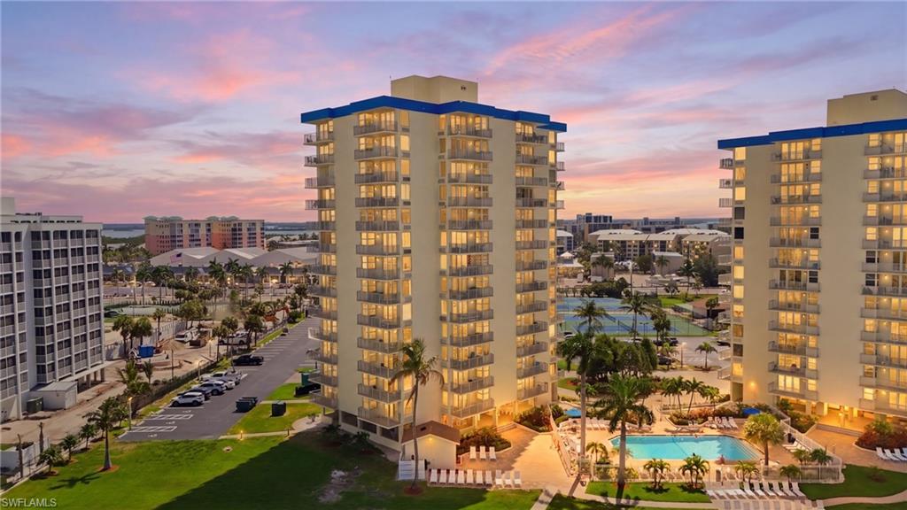 High-rise building with multiple balconies and a blue roof accent - Virtually Edited Image