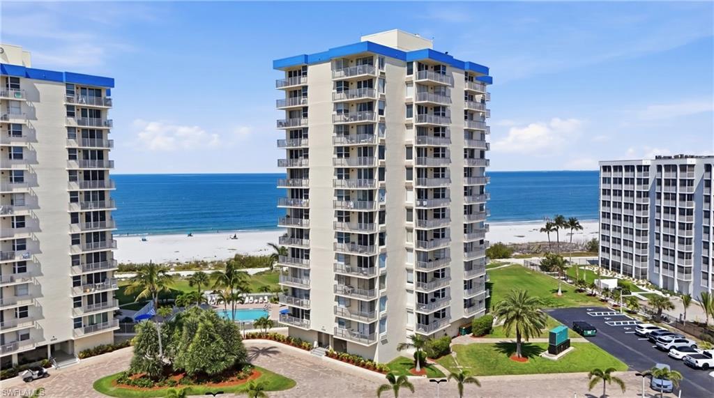 Multi-story residential complex featuring private balconies and a blue roofline accent - Virtually Edited Image