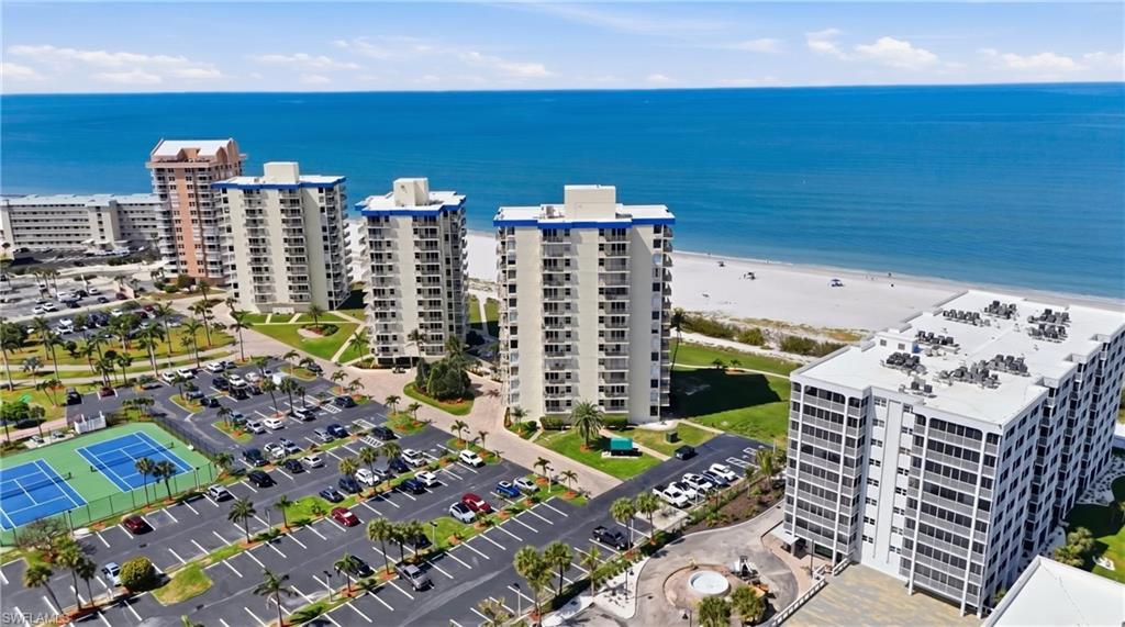 Coastal high-rise buildings offering extensive parking facilities, tennis courts, and direct beach frontage - Virtually Edited Image