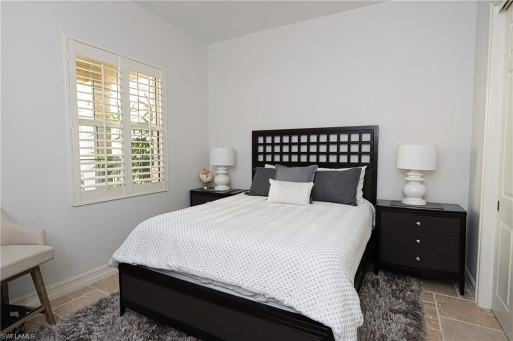 Tiled bedroom with multiple windows