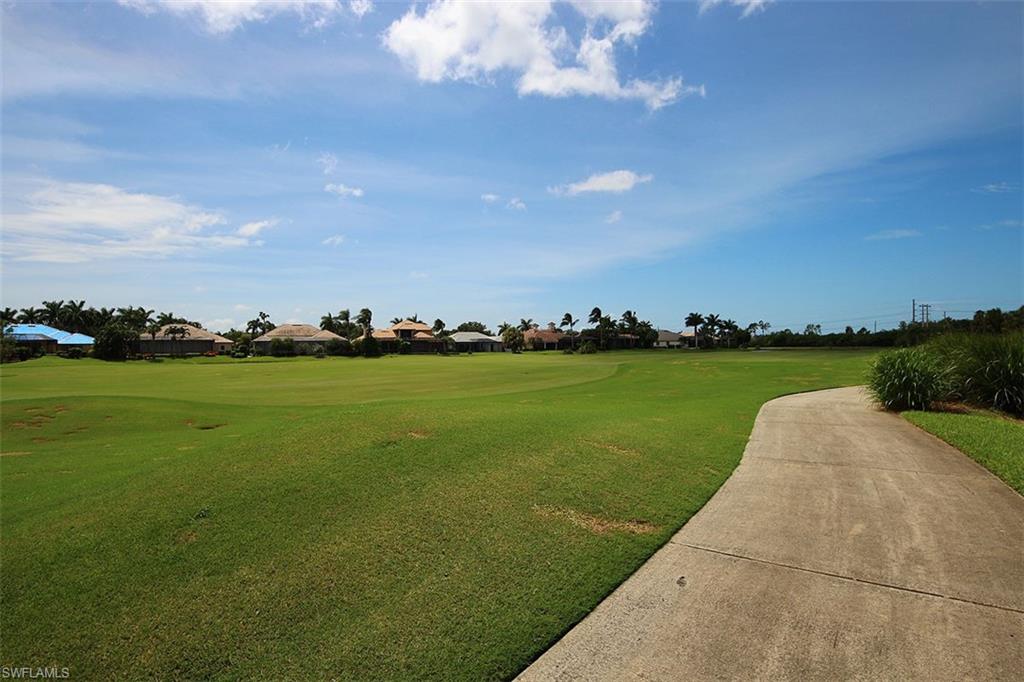 View of home's community with a lawn
