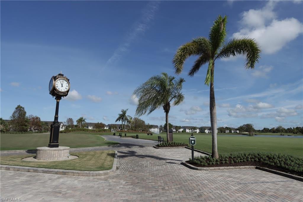 View of home's community with a yard