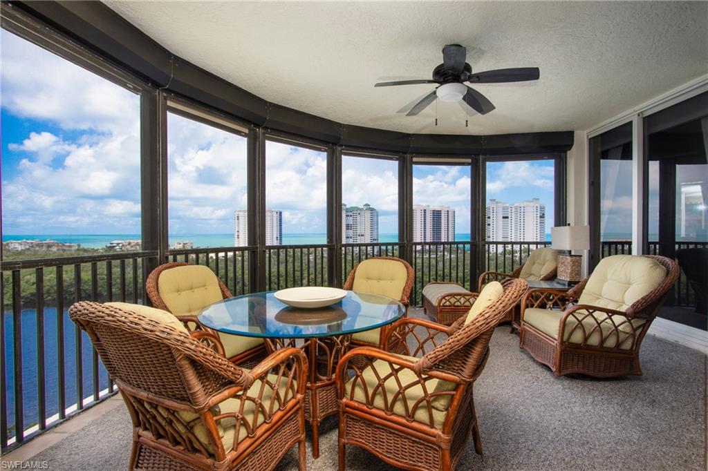 Sunroom / solarium featuring plenty of natural light, ceiling fan, and a water view