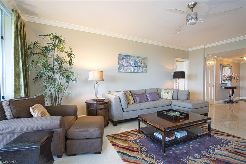 Living room featuring crown molding and ceiling fan