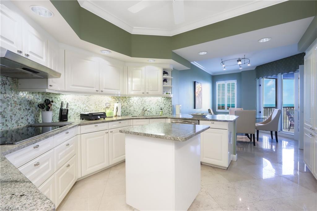 Kitchen featuring a center island, crown molding, and white cabinetry