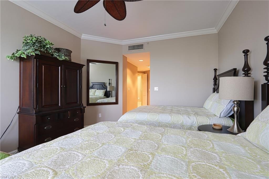 Bedroom featuring ceiling fan and ornamental molding