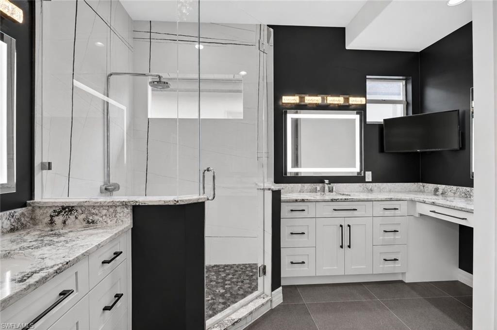 Primary Oasis featuring rainfall showerhead, large vanities, plenty of storage and illuminated LED heated, anti-fog, dimmable, tone adjustable mirrors