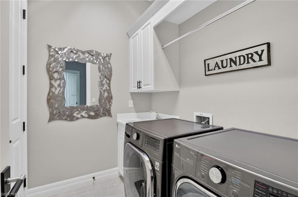 Laundry area featuring white cabinetry, and utility sink