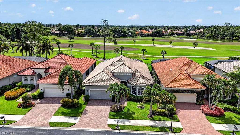 Front of home featuring exceptional rear view of golf course and beautifully manicured landscape