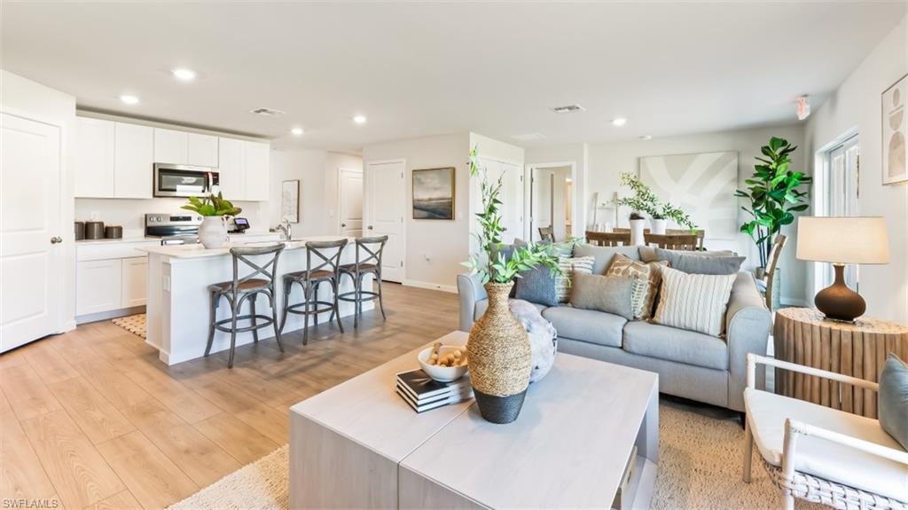 MODEL PHOTO - Living area featuring recessed lighting and light wood-type flooring