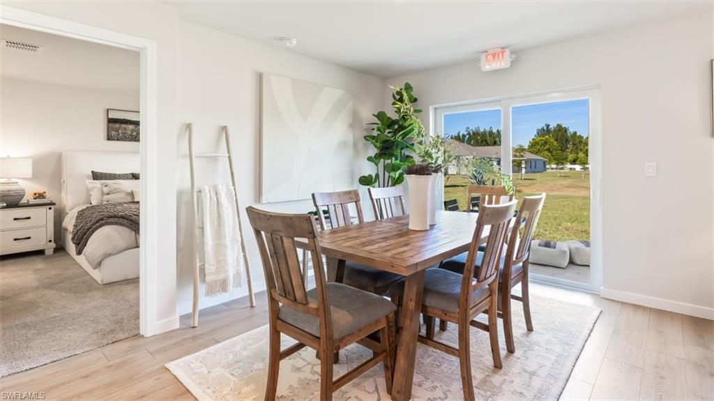 MODEL PHOTO - Dining space with light wood finished floors