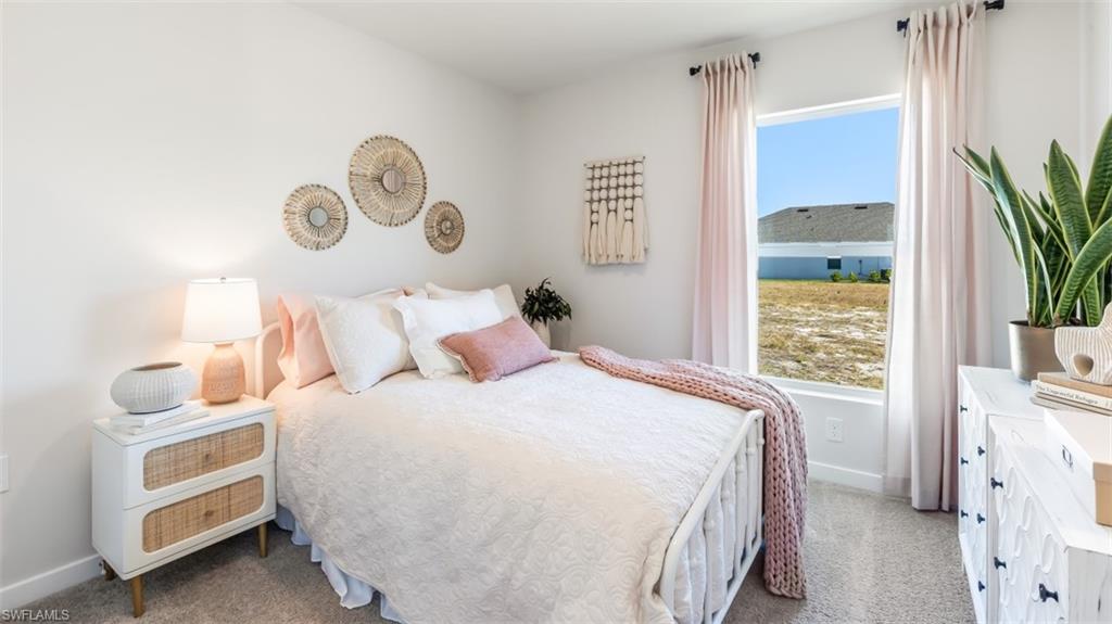MODEL PHOTO - Bedroom with light carpet and baseboards