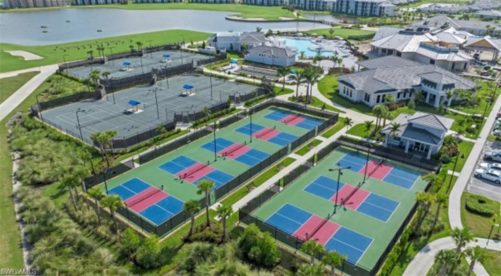 Drone / aerial view of a nearby body of water and a golf course