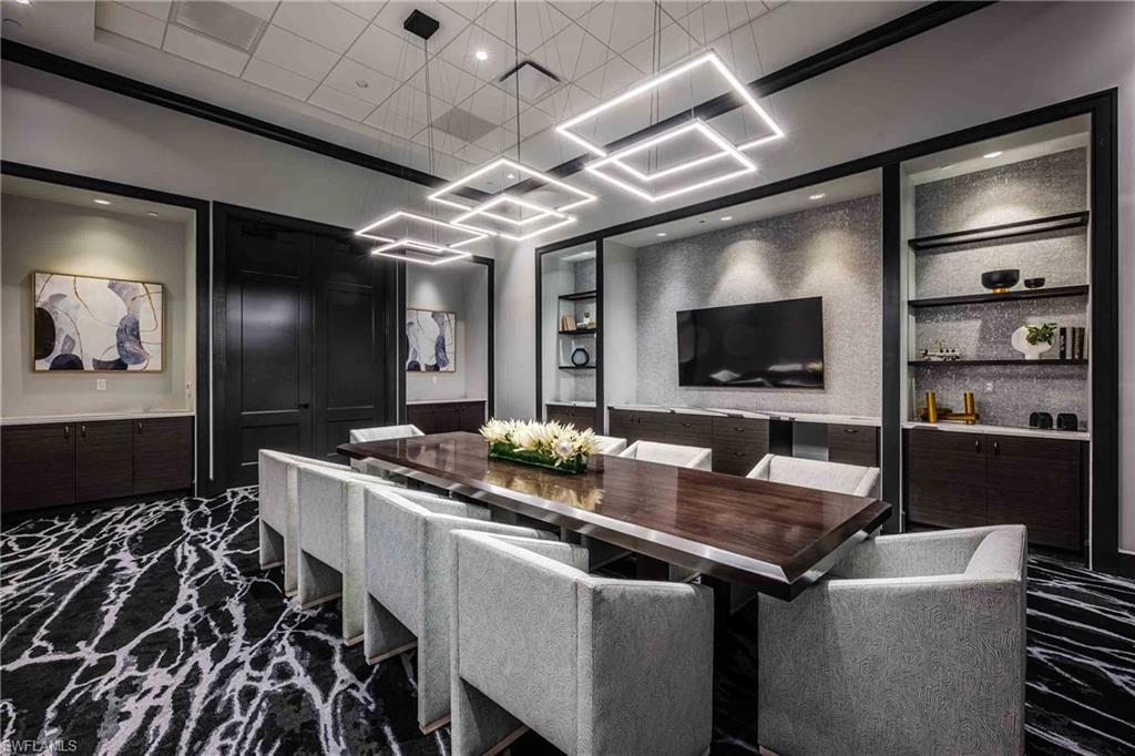 Home theater room featuring built in features, wainscoting, and recessed lighting