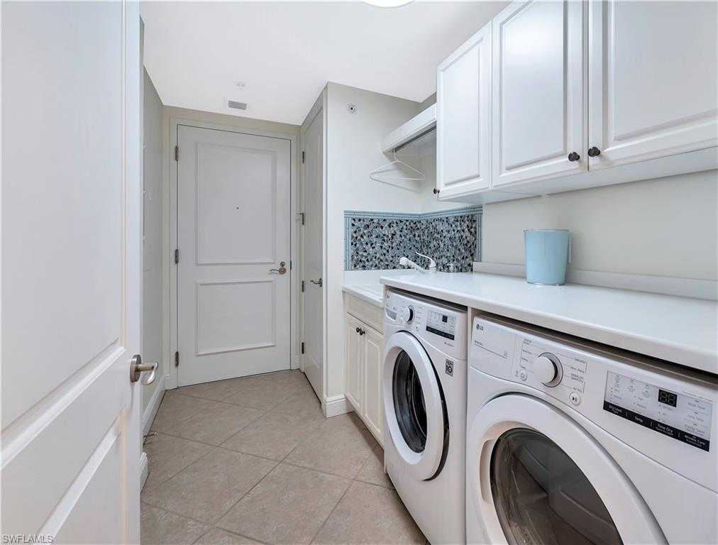 Spacious laundry with sink & hanging rack