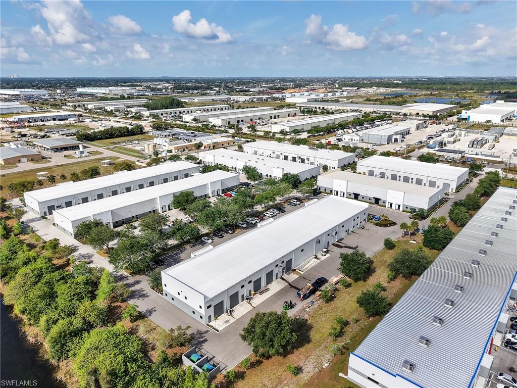 Expansive industrial park featuring multiple modern buildings with white facades and metal roofs
