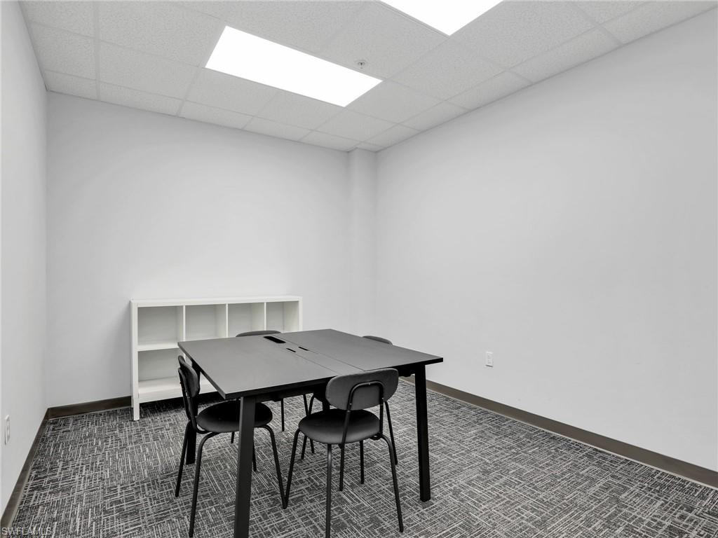 Room featuring white walls and a drop ceiling with recessed lighting