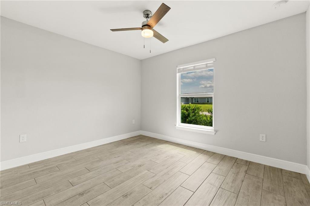 Spacious interior with neutral wall tones and wood-finish flooring