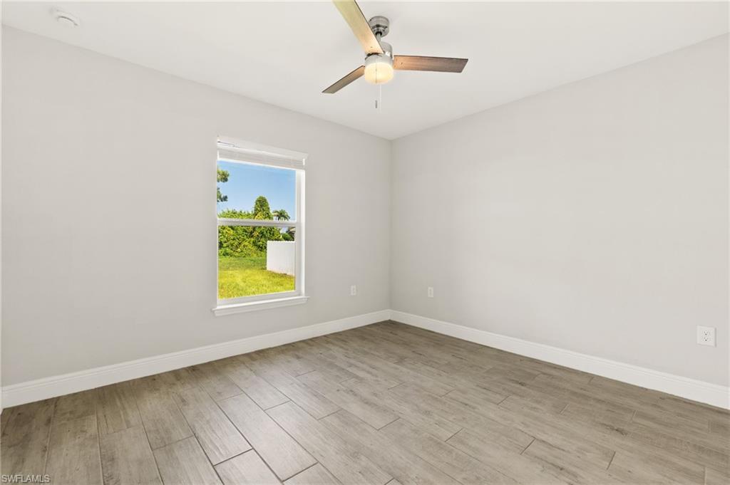 Bright room with light gray walls and wood-finish flooring