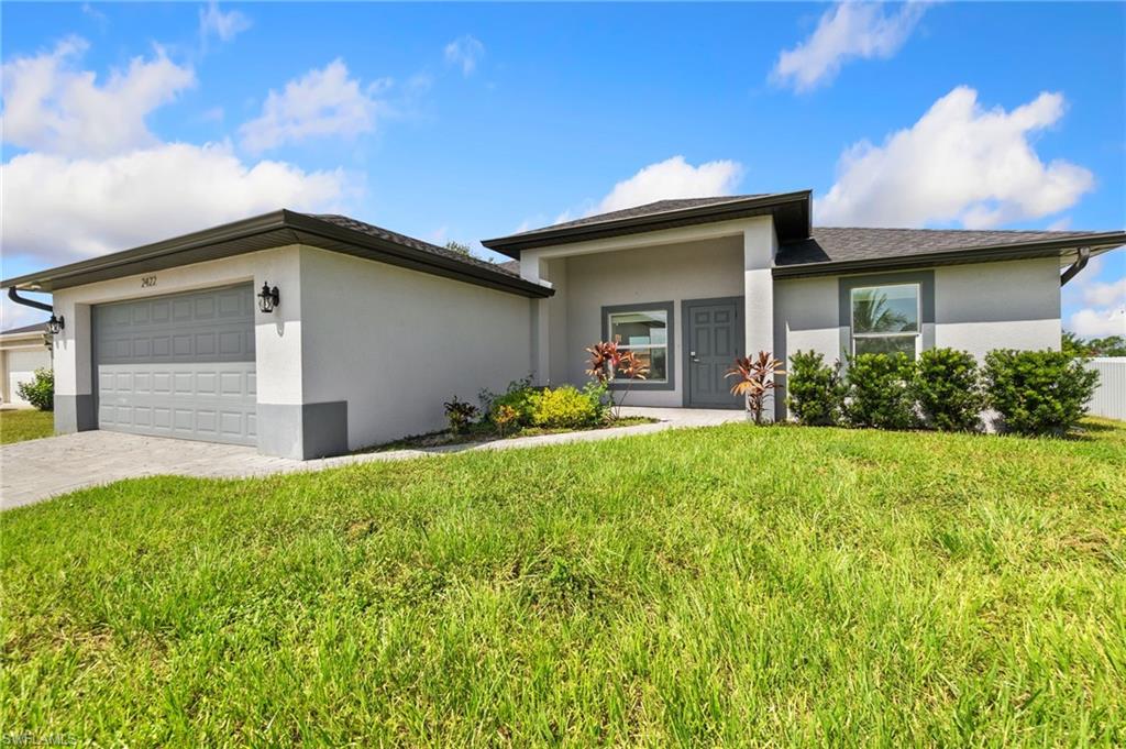 Contemporary single-story residence with a gray garage door and exterior lighting fixtures