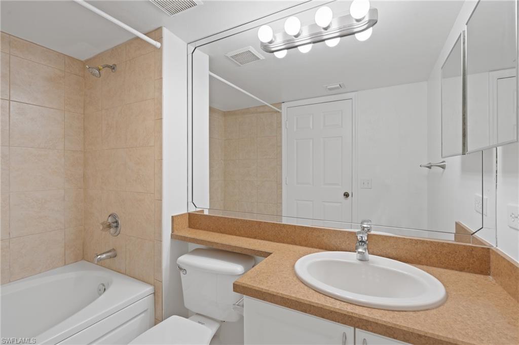 Bathroom featuring visible vents, toilet, and vanity