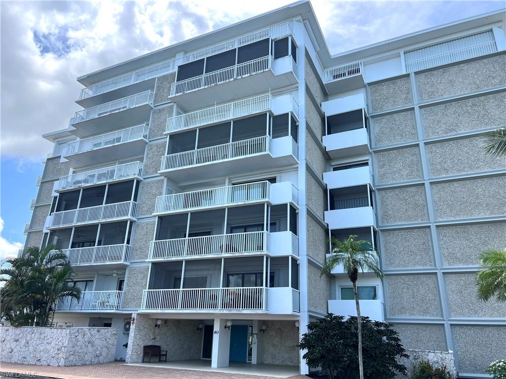 Multi-story condominium building featuring a textured exterior facade and multiple private balconies