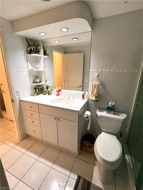 Bathroom featuring two doors for access. One from the main hallway and the other from the bedroom vanity.