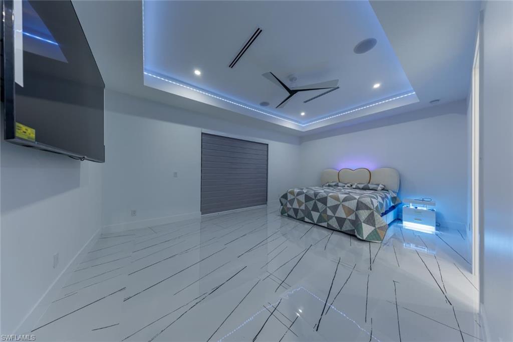 Master Bedroom with a raised ceiling and recessed lighting