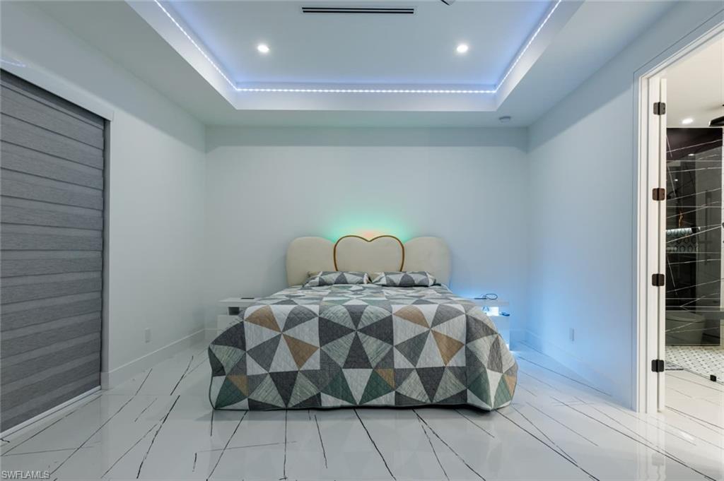 Master Bedroom featuring a tray ceiling and recessed lighting
