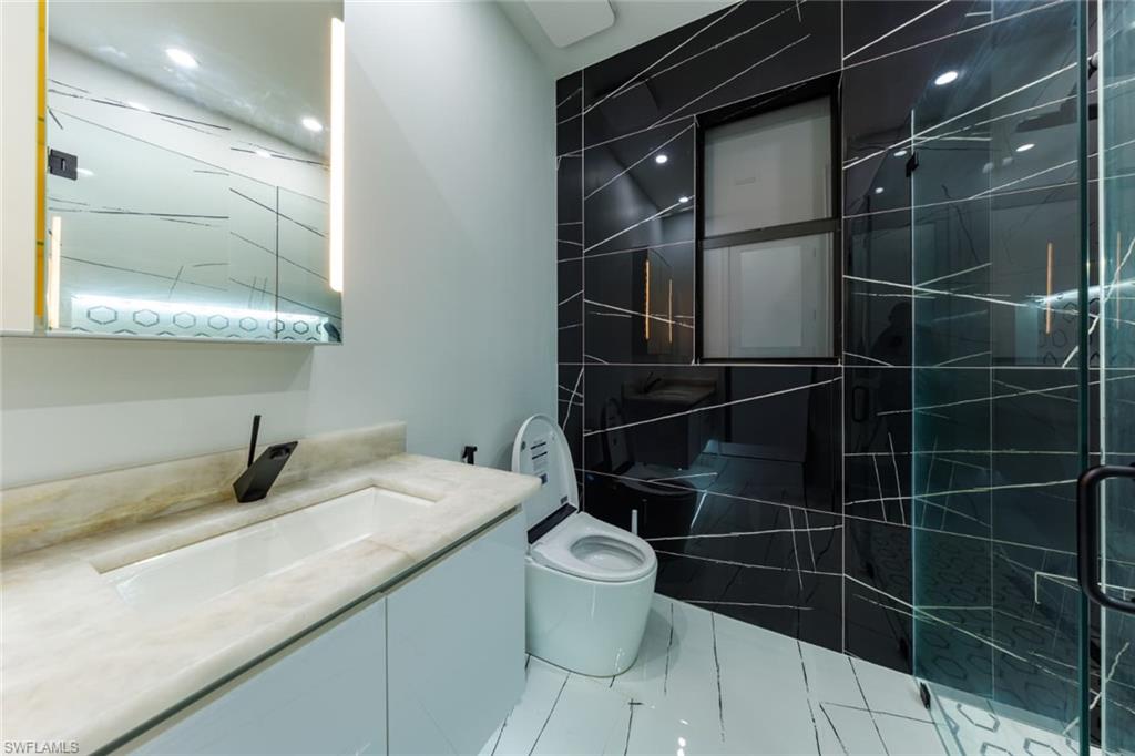 Bathroom with vanity and a stall shower