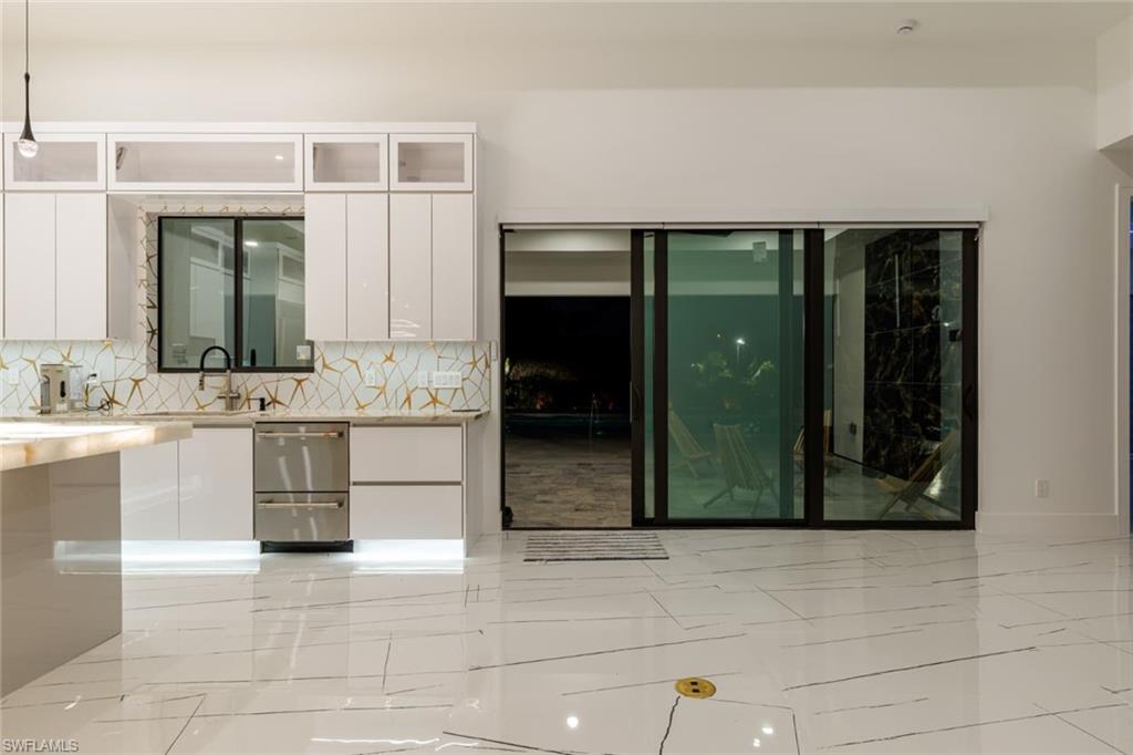 Kitchen featuring backsplash, modern cabinets, Sliding doors to Lanai area